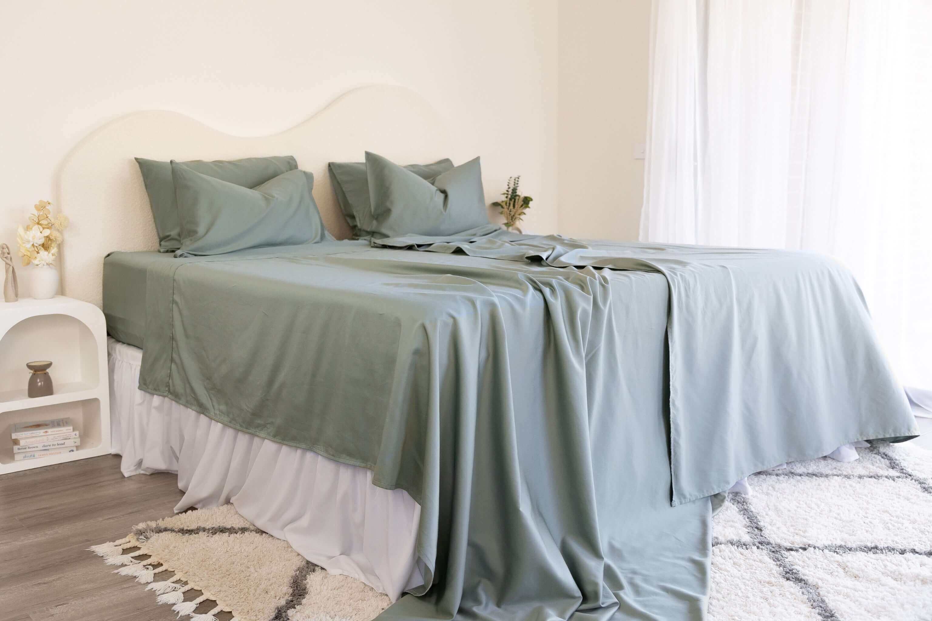King/Queen bamboo cotton sheet set in eucalyptus green styled on bed