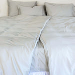close up of twin single bamboo cotton Quilt cover set in grey sage styled on bed