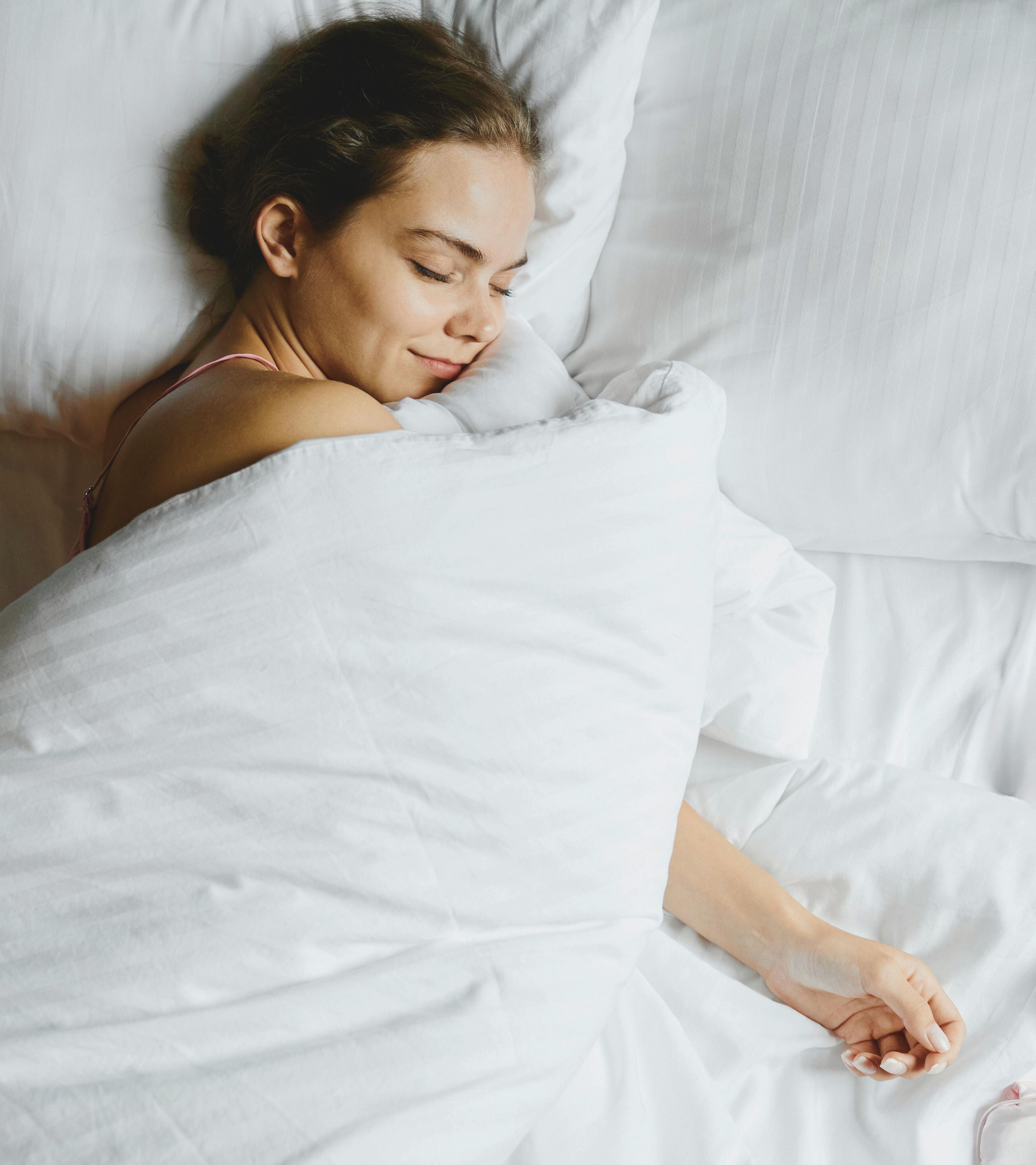 women happily cuddling a doona