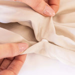 close up of snap button closer on beige quilt cover