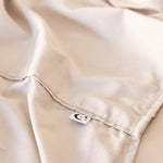Close up of King/Queen bamboo cotton sheet hemming in beige