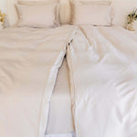 Close up of twin single bamboo cotton quilt cover set in beige styled on bed