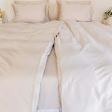 Close up of twin single bamboo cotton quilt cover set in beige styled on bed