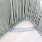eucalyptus green fitted sheet corner support strap labelled with bottom