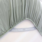 eucalyptus green fitted sheet corner support strap labelled with bottom
