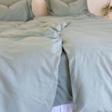close up of twin single  quilt cover set in eucalyptus green styled on bed