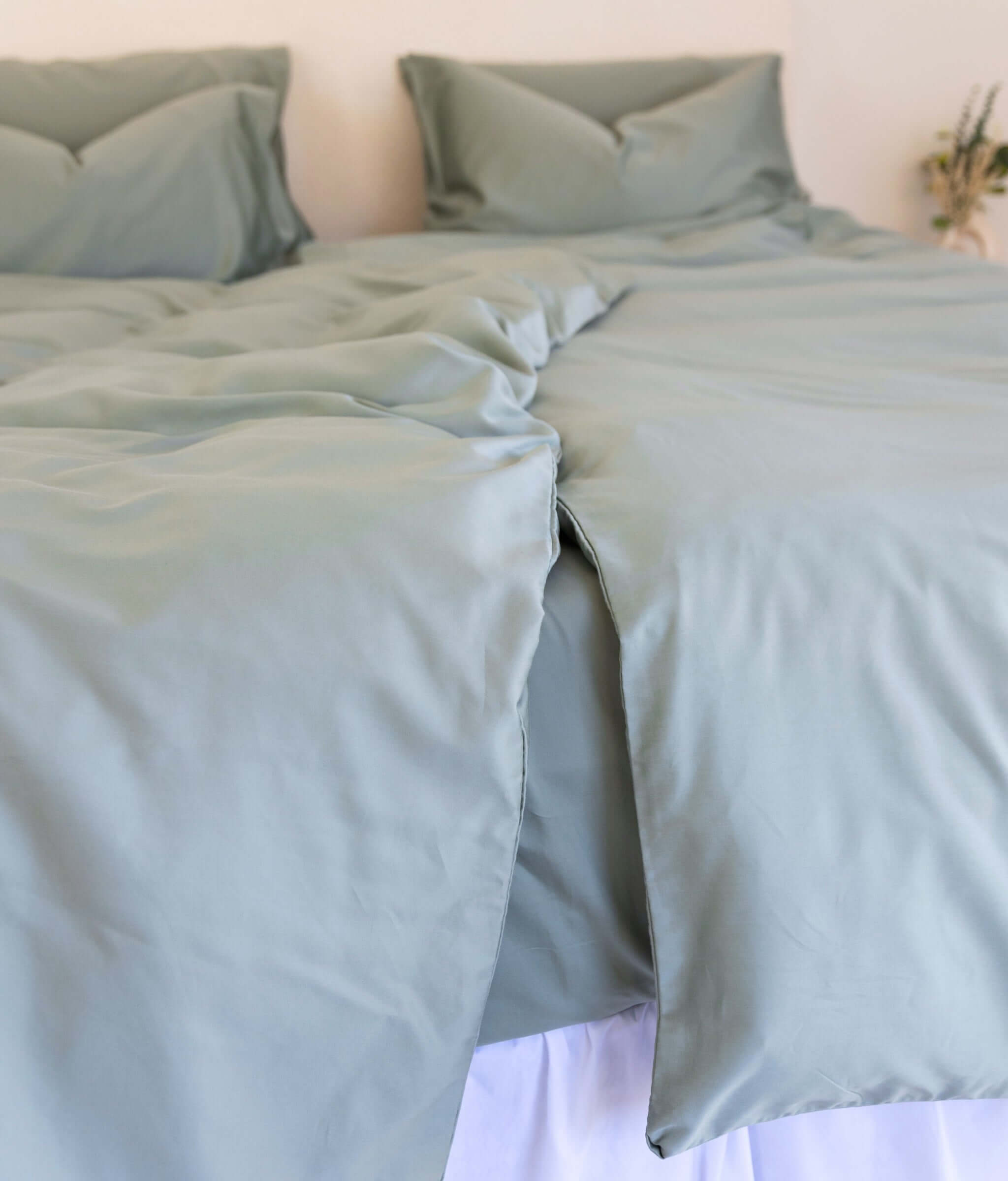 close up of twin single  quilt cover set in eucalyptus green styled on bed