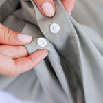 close up of bamboo cotton eucalyptus green snap button closure