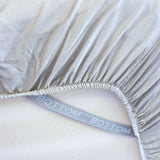 grey sage fitted sheet corner support strap labelled with bottom