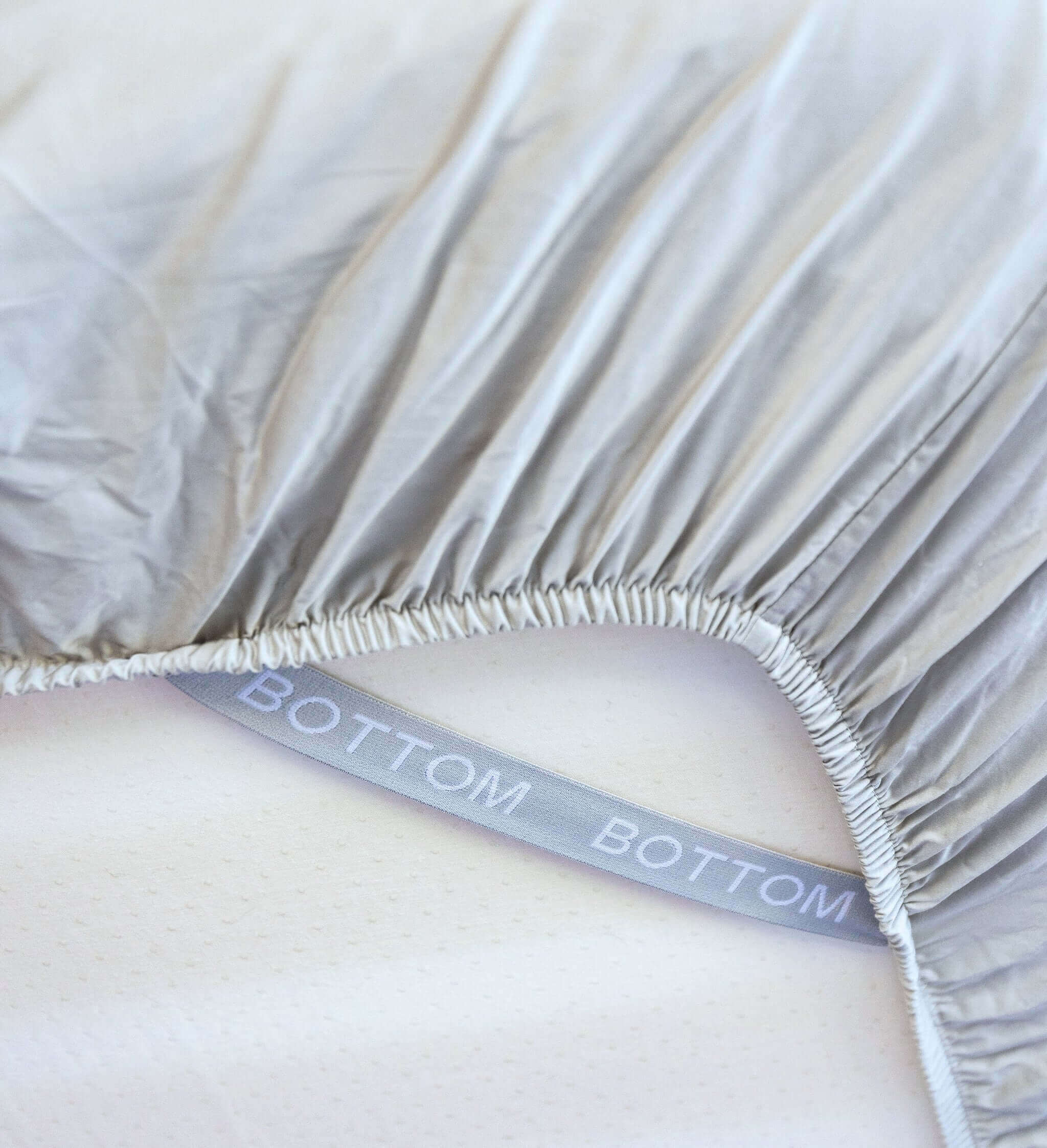 grey sage fitted sheet corner support strap labelled with bottom