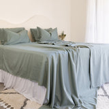 King/Queen bamboo cotton sheet set in eucalyptus green styled on bed