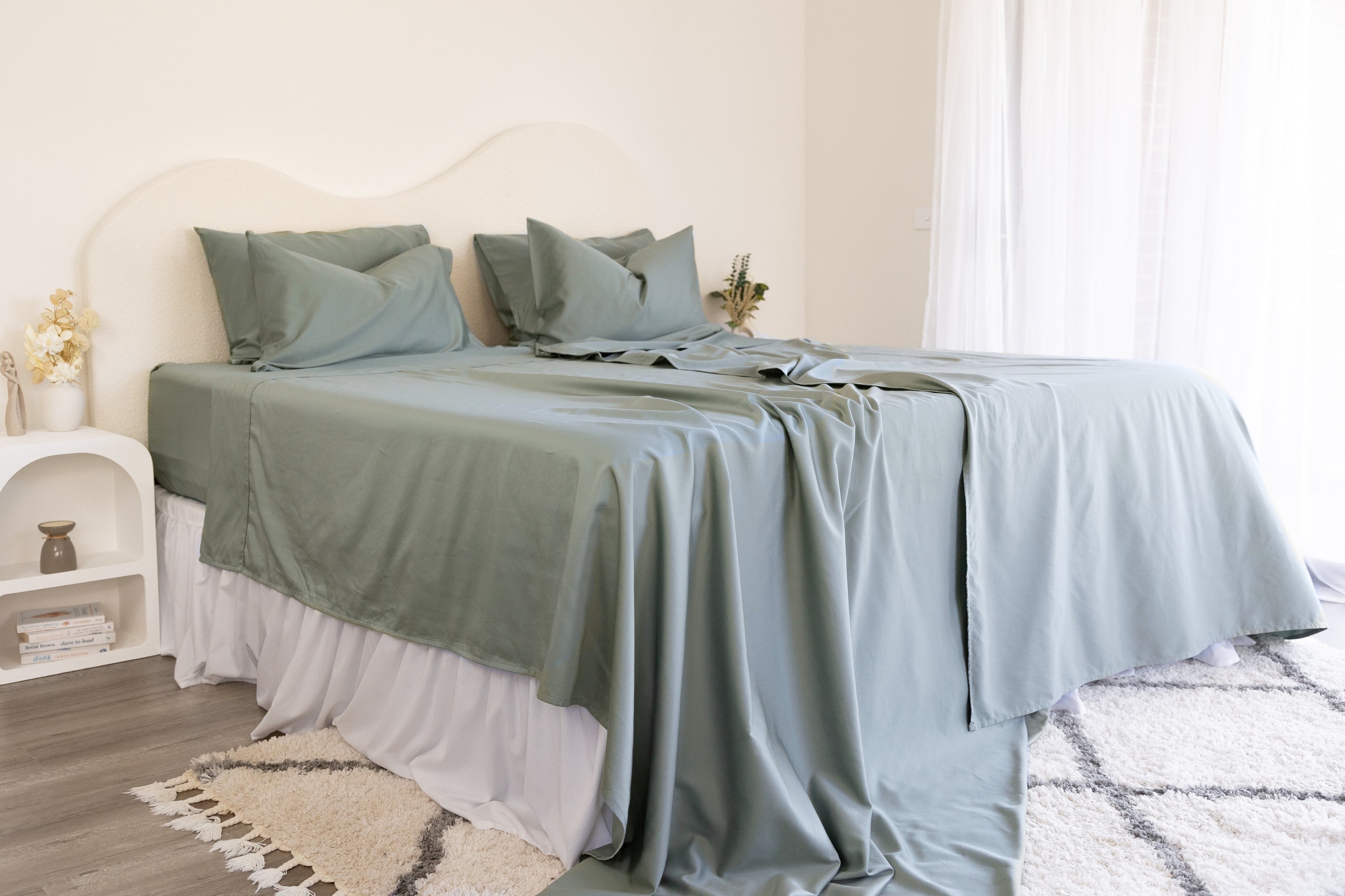 King/Queen bamboo cotton sheet set in eucalyptus green styled on bed
