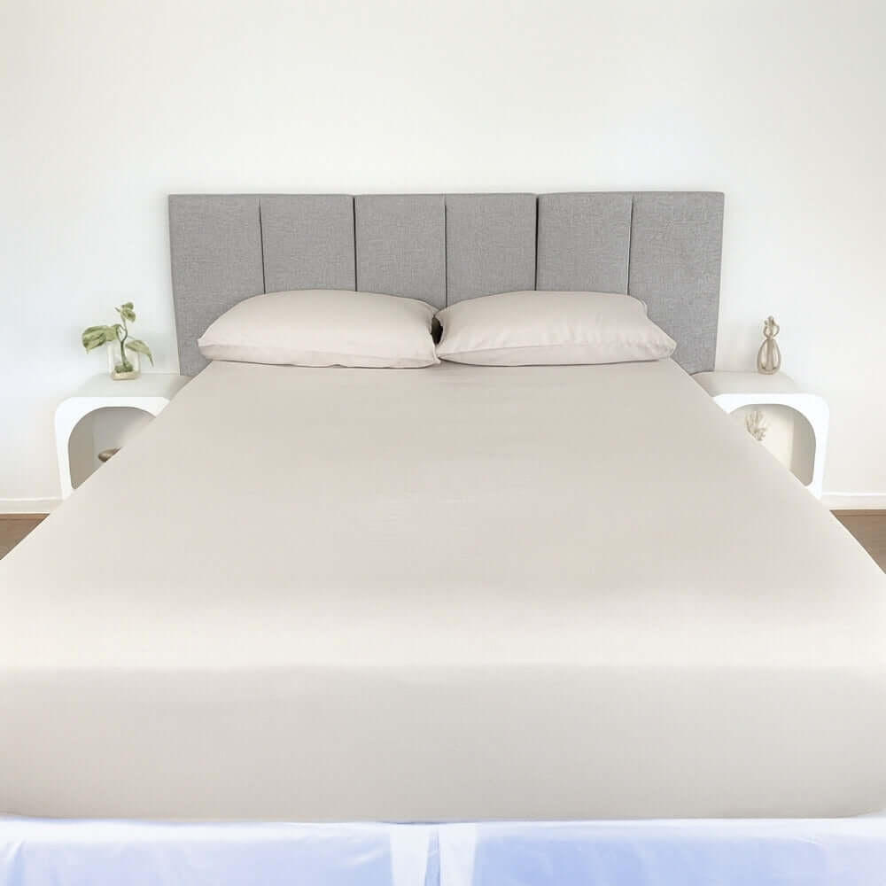 bed styles with beige fitted sheet and 2 matching pillows with grey headboard