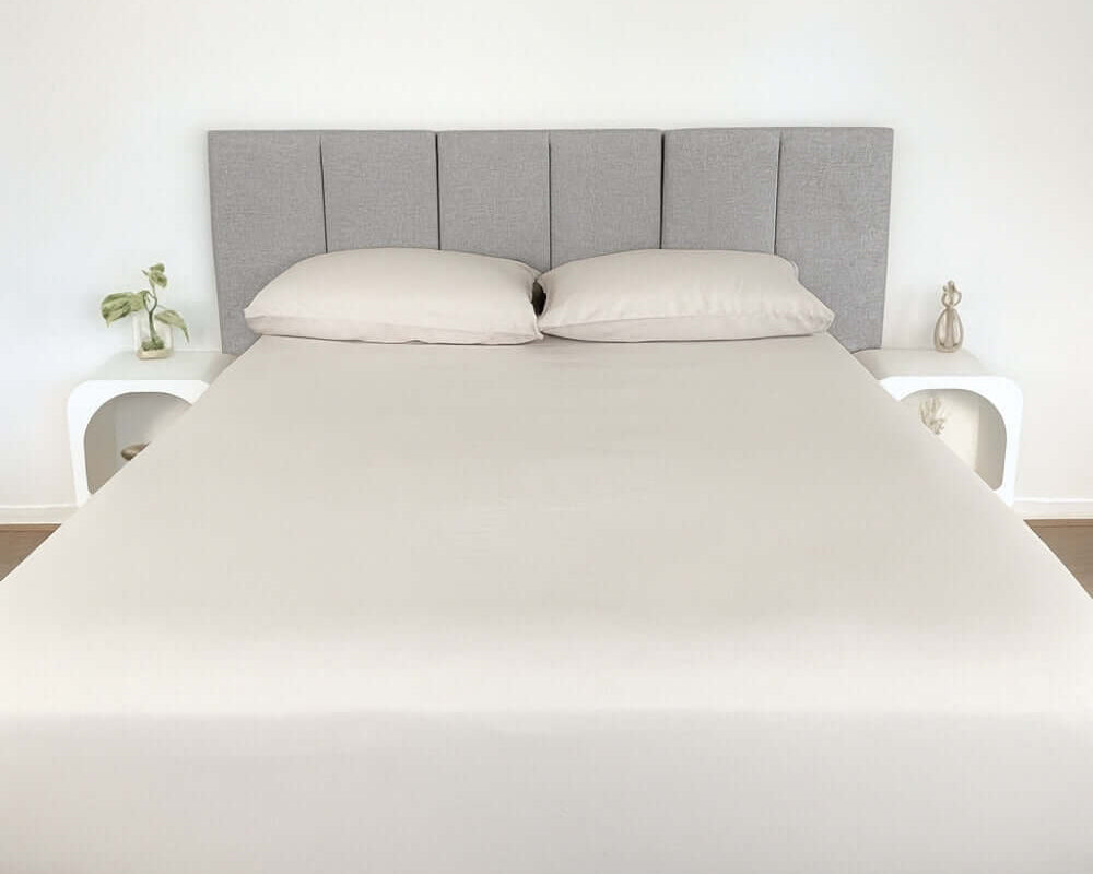 bed styles with beige fitted sheet and 2 matching pillows with grey headboard