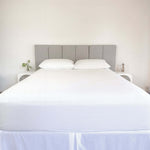 bed styles with white fitted sheet and 2 matching pillows with grey headboard