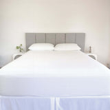 bed styles with white fitted sheet and 2 matching pillows with grey headboard