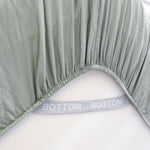 eucalyptus green fitted sheet corner support strap labelled with bottom