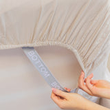 beige fitted sheet corner support strap labelled with bottom