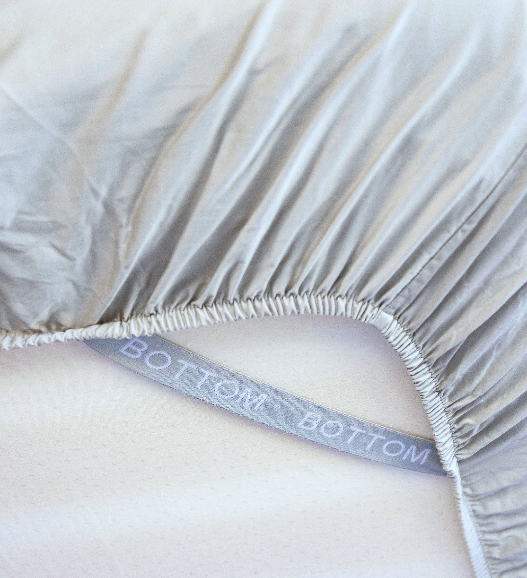 grey sage fitted sheet corner support strap labelled with bottom