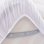 white fitted sheet corner support strap labelled with bottom